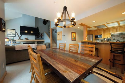 Gather around your rustic dining table for memorable meals, with a fully equipped kitchen and cozy living area creating the perfect social hub.