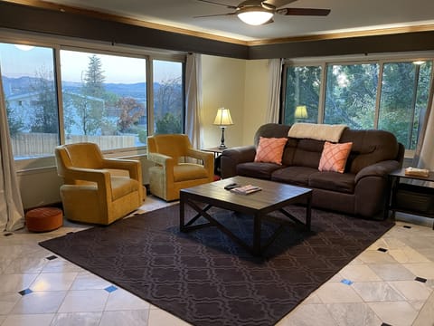 Huge living room with Views of mountains, downtown and tress.