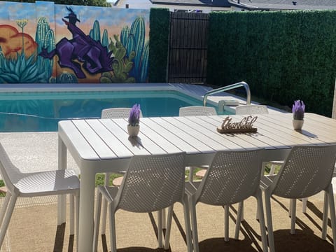 Outdoor dining room table overlooking the mural.