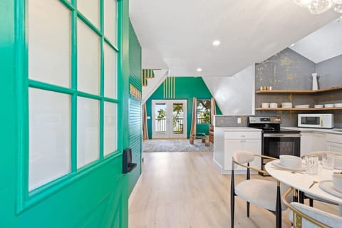 Enter through the vibrant green door into this cozy, modern space.