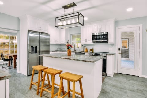 The kitchen is fully stocked with cookware and utensils, and several appliances