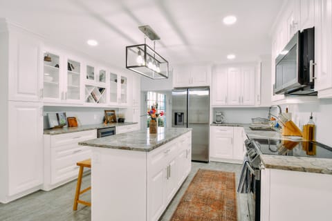 A chefs kitchen with brand new appliances, and everything needed to cook meals