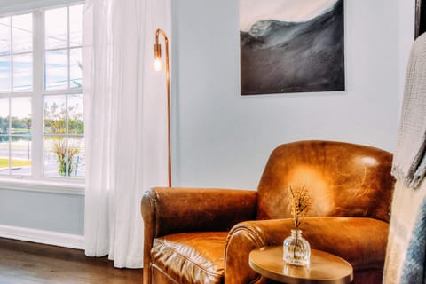 This vintage leather chair completes the reading nook in the Elby Great room