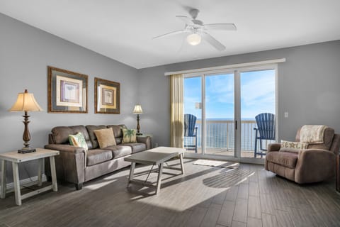 Living Room - A perfect blend of luxury and comfort, this beachfront living room has a soft sofa, a comfy recliner, a large flat-screen TV, and breathtaking ocean views through glass doors.