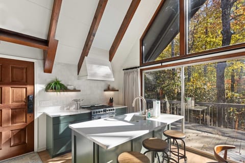 Custom Kitchen with Quartz Countertops and Dining for Three as the Island