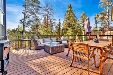Relax on the scenic deck with comfortable seating and peaceful views of the surrounding trees and beautiful pine forest scenery.
