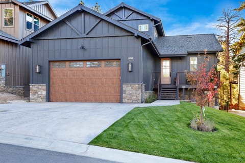 Welcoming cabin entry surrounded by towering pine trees, offering fresh mountain air and a peaceful forest setting—the perfect first impression for your Big Bear Lake getaway.