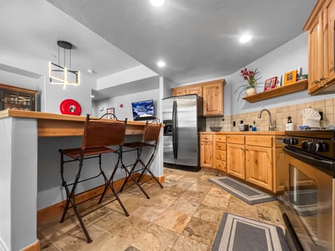 Bright and open kitchen with bar and table seating