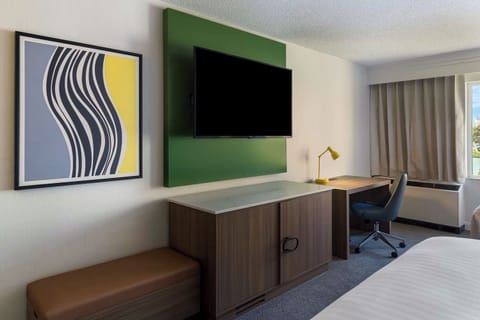 Work comfortably at the desk beside daylight and blackout drapes.