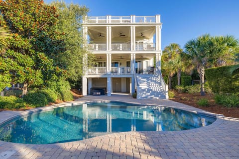 Elegant Coastal Home with Private Pool – Stunning exterior shot showcasing three levels of luxury living.