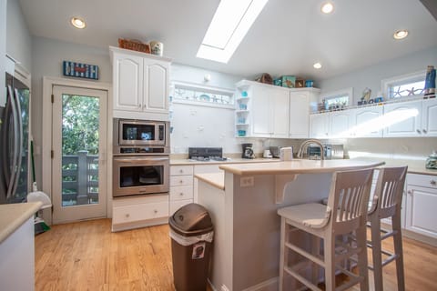 Kitchen, 2nd floor, 2 seats at bar, coffee pot, access to back screened porch