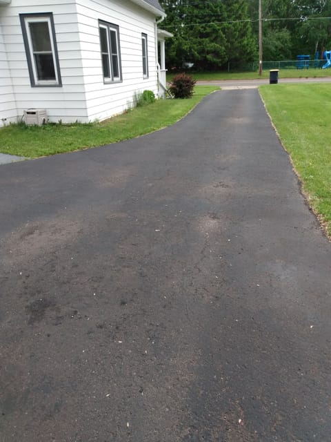 Driveway is 91 feet long, 10 wide and widens to 23.5 feet in front of garage.