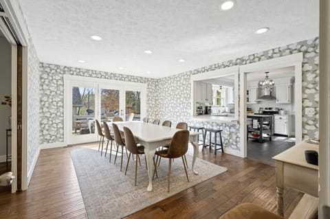 The dining room sits between the kitchen and living room. French doors lead out to the deck.
