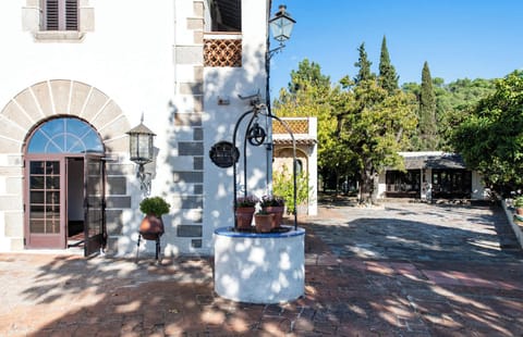 Charming Spanish colonial exterior with courtyard fountain and lush greenery