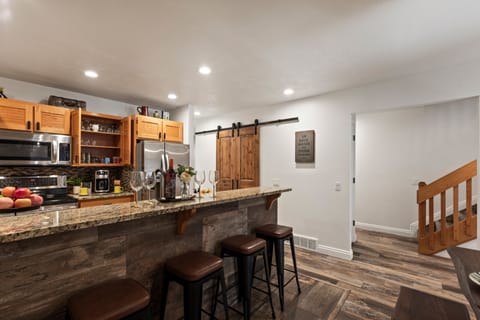 Granite counters and a pantry behind the barn door
