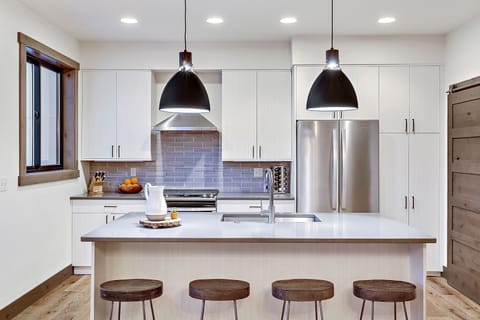 Open plan kitchen with modern appliances and breakfast bar