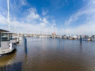 Beautiful houseboat in Marina of Volendam Docked boat in Volendam