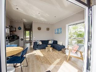 Modern houseboat, top location with an unobstructed view of the Lake Docked boat in Friesland, Netherlands