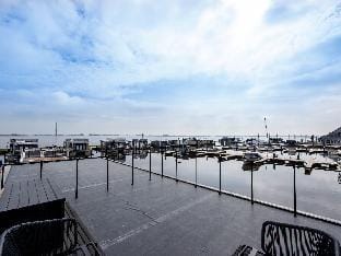 Modern houseboat, top location with an unobstructed view of the Lake Docked boat in Friesland, Netherlands