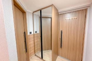 Wooden Accent 3BR Condo Puncak Marina By Travelio Apartment in Surabaya