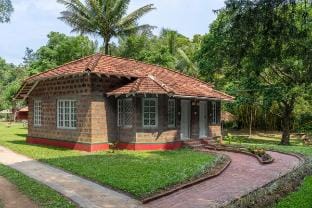 Timber Cottage by Raho: Stream-View Estate Escape Vacation rental in Karnataka