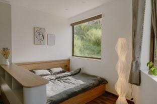 The room has a view of the house and pine hill Vacation rental in Dalat