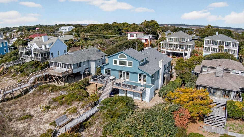 Elevated aerial perspective showcasing the property nestled beautifully along the coastline.
