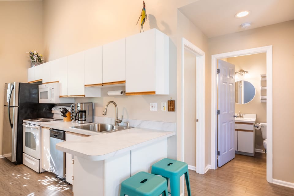 Kitchen features a countertop breakfast bar.