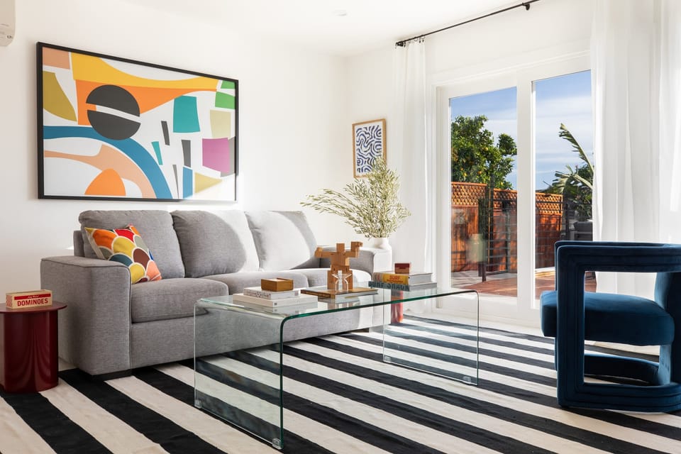 Living room leads to gorgeous outdoor deck and features a pull out sofa.