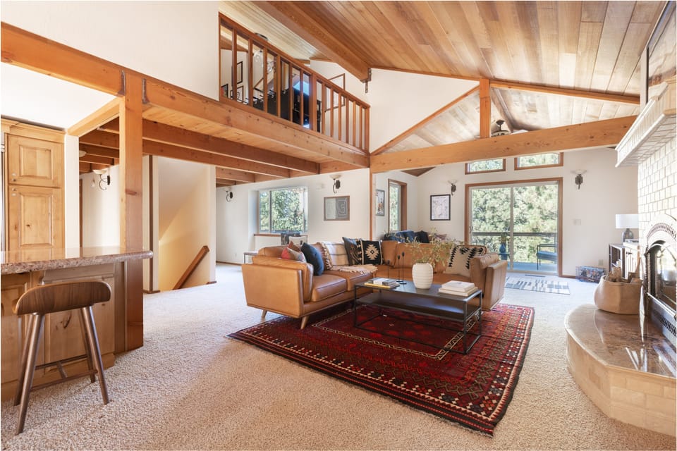 Open concept floor plan connecting the kitchen, living room, loft, and patio.
