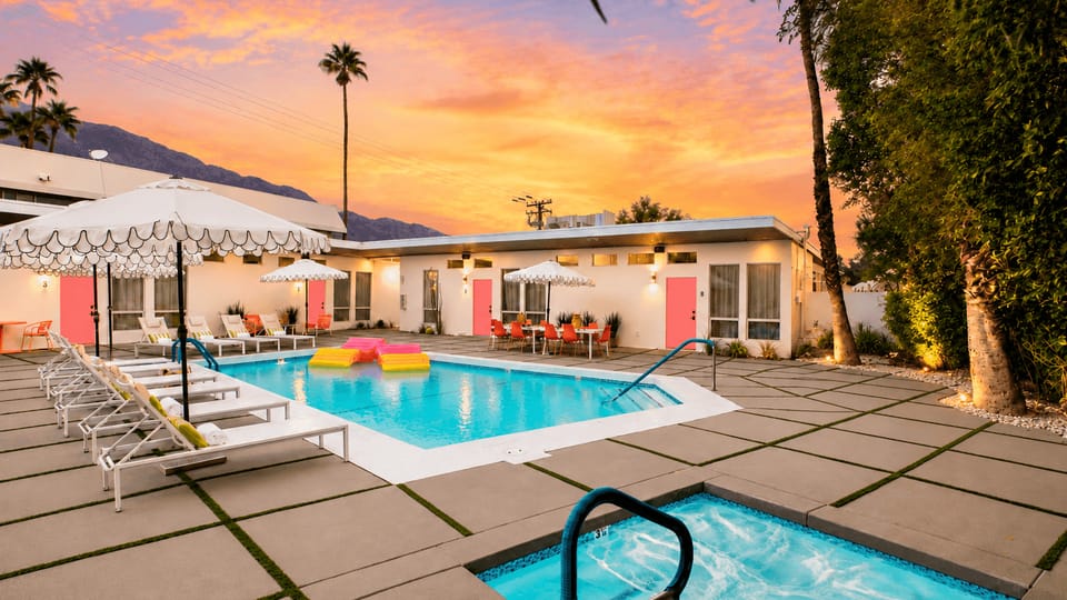Unwind in the jacuzzi while mountain views stretch beyond the colorful Rosalie grounds.
