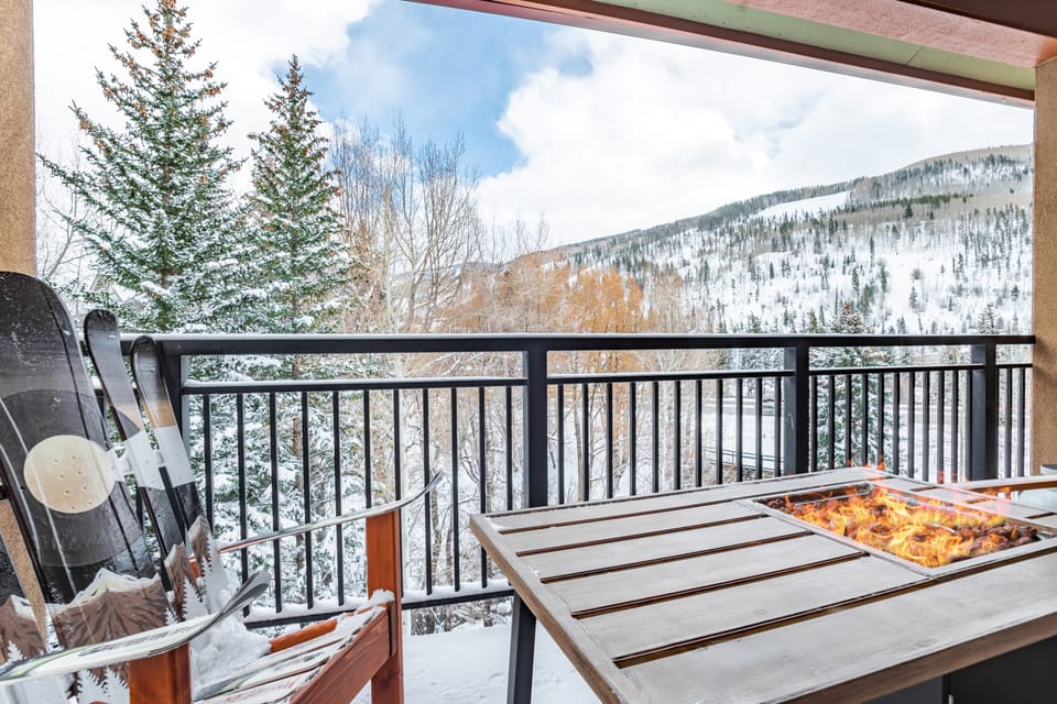 Private balcony with a firepit table, BBQ grill, and views.