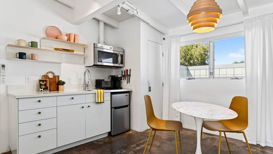 A compact kitchenette and sunny dining nook make it easy to handle morning coffee, quick bites, and simple meals during your stay.