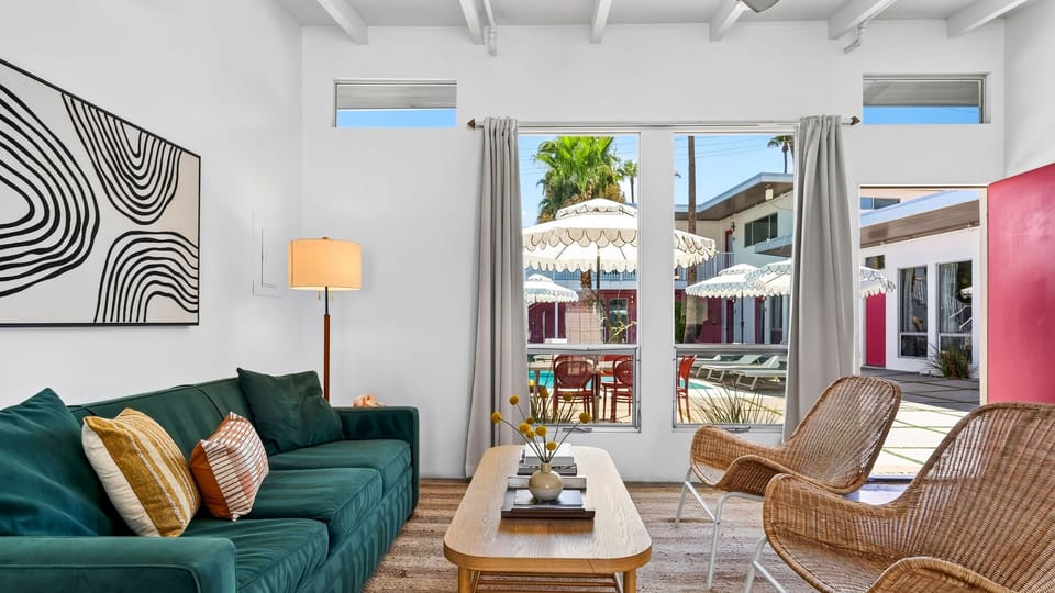 A stylish lounge opens directly to the pool courtyard, with plush seating and bright windows that keep the space feeling light and connected.