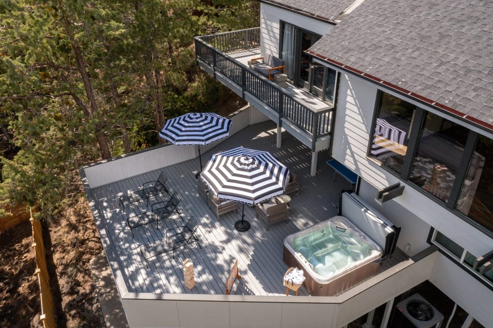 Multiple spacious decks with fire pit, dining, ping pong, and all-around lounging.