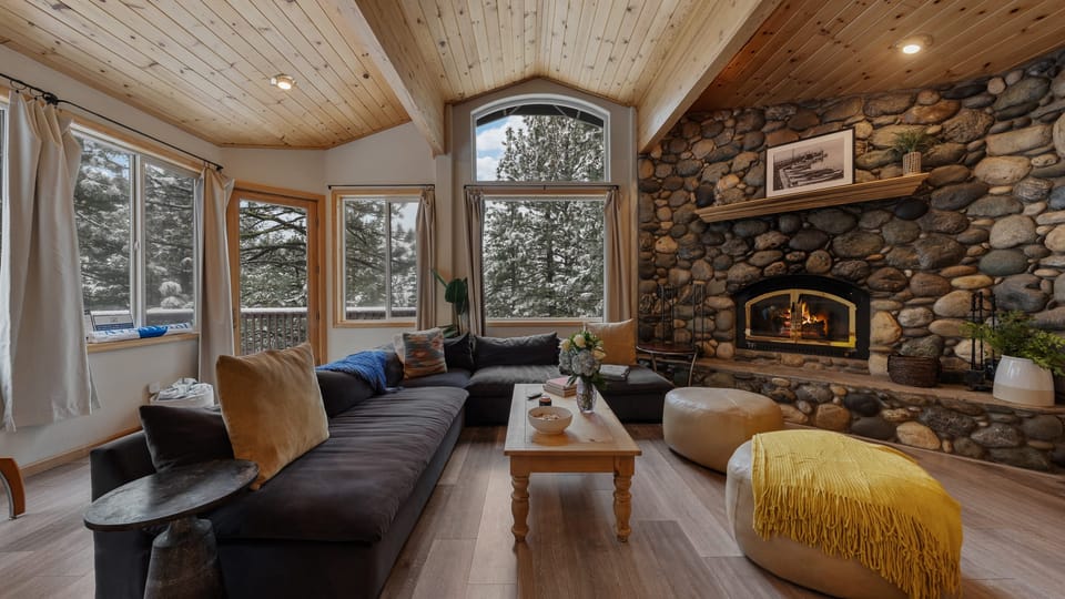 Stay cozy by the stone-walled fireplace in the living area.