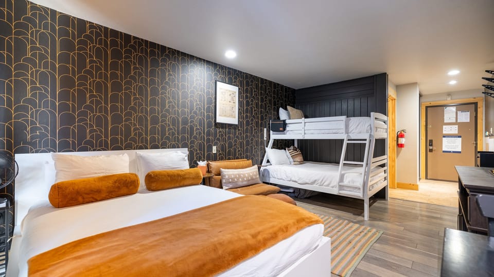 The modern bedroom features a contemporary interior design, complete with a queen bed and a bunk bed.