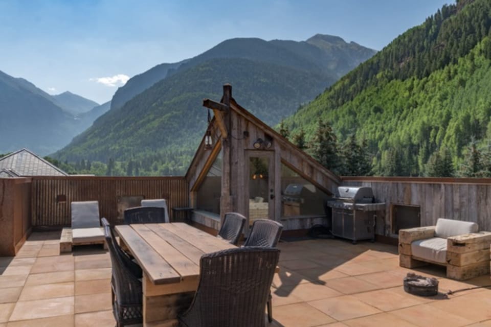 Spacious deck with outdoor dining and ample seating options.