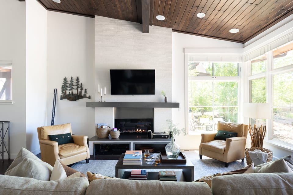 Living room features a TV and fireplace with lots of comfortable seating.