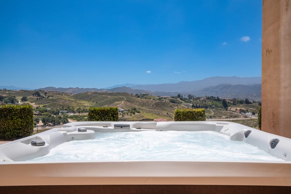 Soak in the hot tub while looking over the landscape.