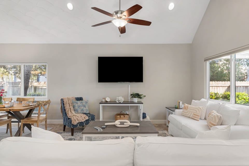 Living room features two couches and a TV.