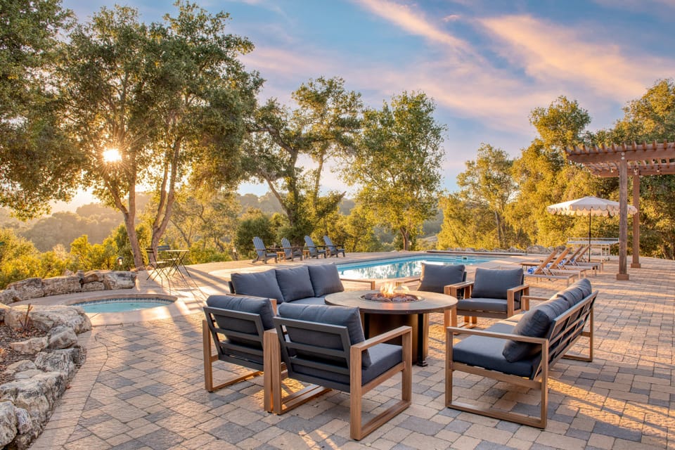 Firepit with comfortable seating near the pool and hot tub.