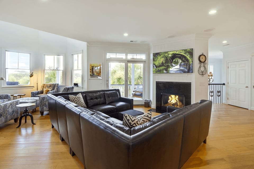 Living area with fireplace and comfy seating.