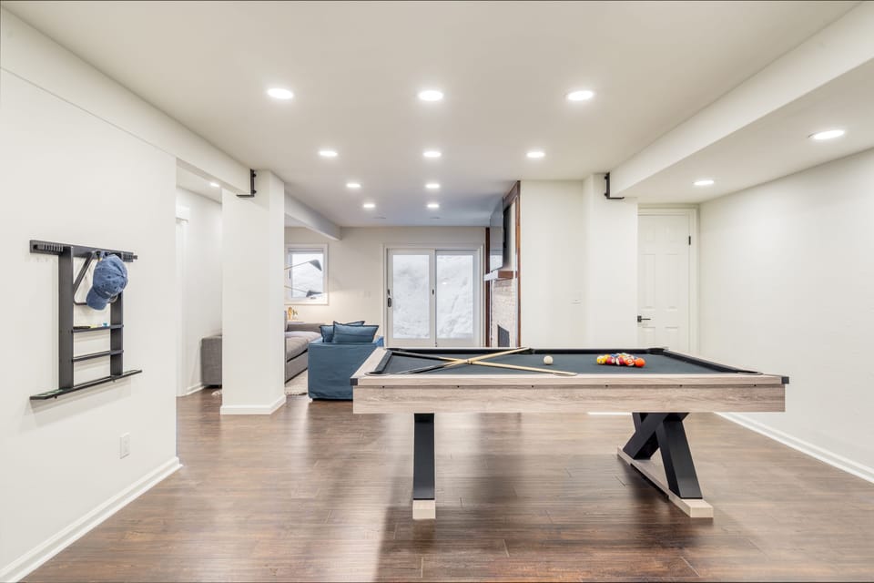 Downstairs living area with pool table and TV.