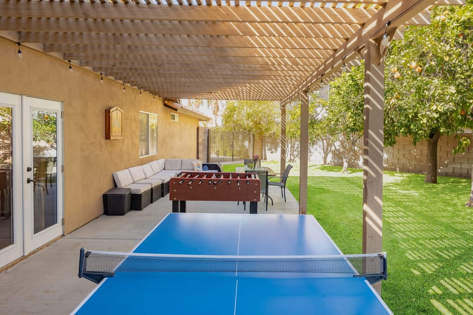 The patio in the side yard features ping-pong and foosball.