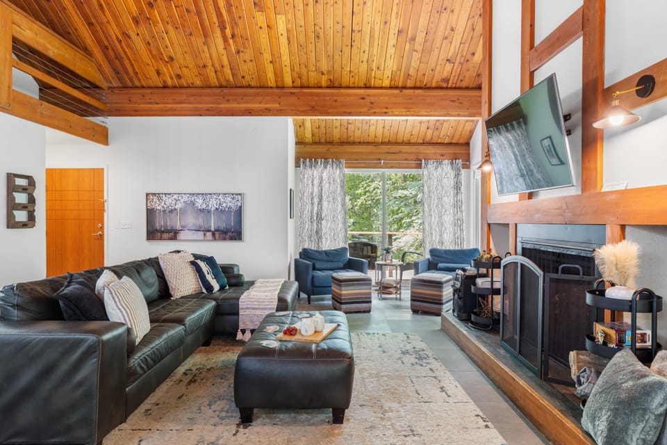 Gather in the cozy living room with plush seating and a warm fireplace, perfect for relaxing evenings.