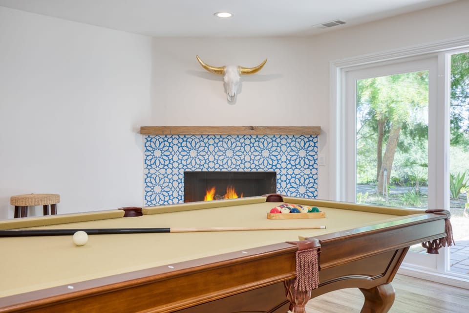 Pool table near the fireplace.