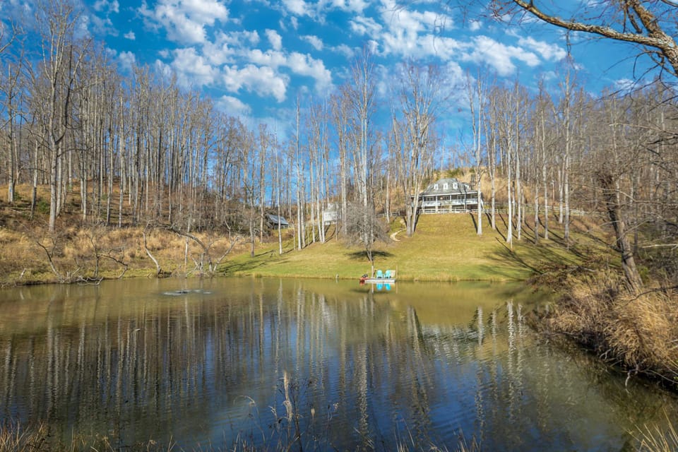 A picturesque mountain home overlooks a sprawling private pond.