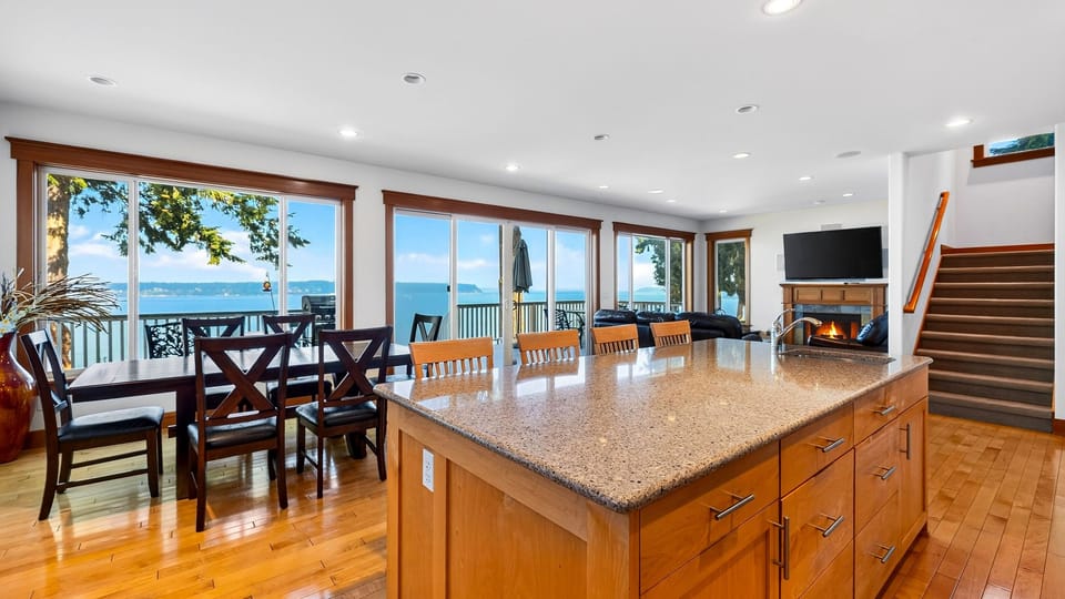 Gather around the expansive kitchen island while sweeping Sound views fill the open living and dining space.