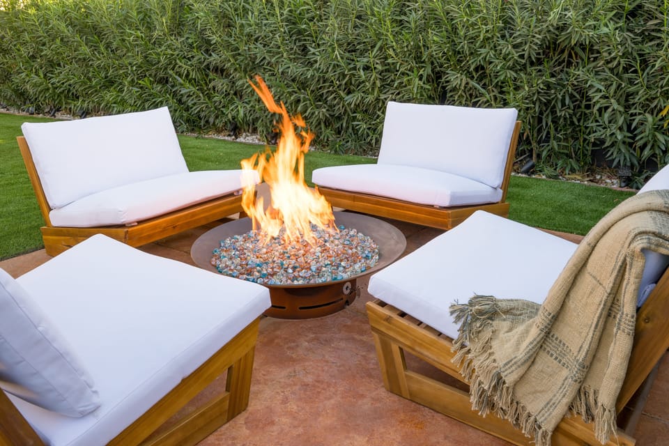 Comfortable seating around the firepit in the backyard.